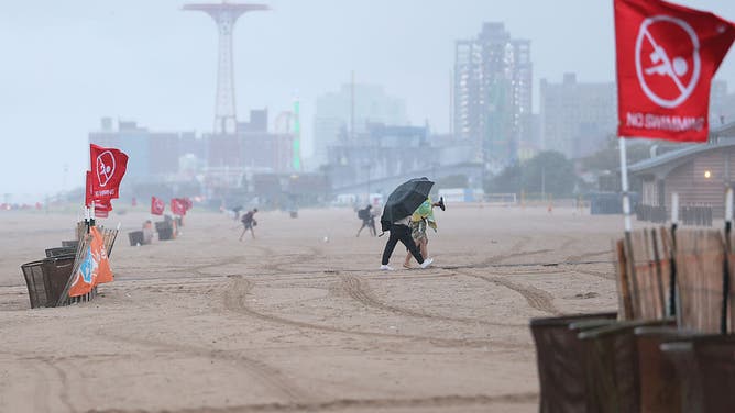 Red "No Swimming" flags are seen in Brighton Beach amid Hurricane Erin on August 20, 2025 in the Coney Island neighborhood of the Brooklyn borough in New York City. NYC Mayor Eric Adams and Iris Rodriguez-Rosa, the parks commissioner, announced that city beaches would be closed for several days as rip currents and rough waters are expected along the East Coast due to Hurricane Erin.