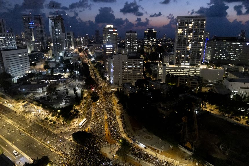 Protesters march during a rally calling for the Israeli government to sign a deal to release the hostages held in Gaza, on Tuesday, in Tel Aviv, Israel.