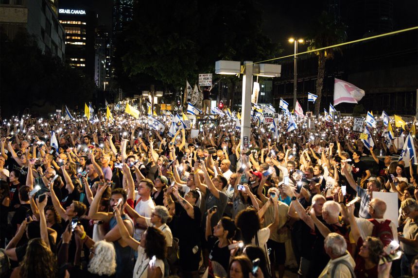 Protesters in Tel Aviv hold up their lit-up cellphones during a demonstration organised by the families of the Israeli hostages.