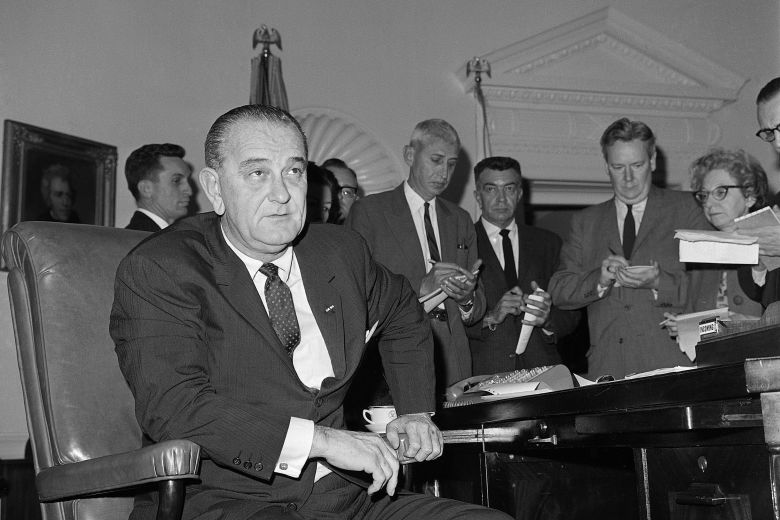 President Lyndon B. Johnson sits at his desk in Washington, DC, before announcing he would federalize the Alabama National Guard to protect civil rights demonstrators in Selma, Alabama, on March 18, 1965.