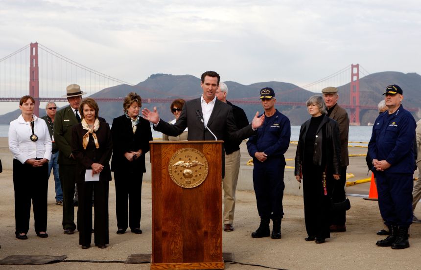 Then-San Francisco Mayor Newsom speaks to reporters after touring an oil affected beach at Crissy Field on November 12, 2007.