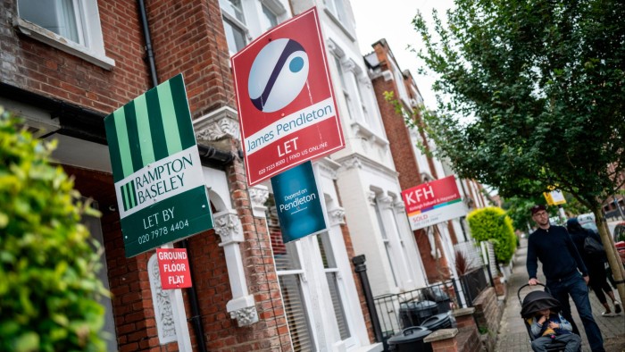 Estate signs outside red-brick houses