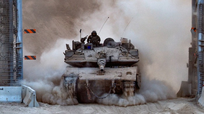 An Israeli tank enters Israel from Gaza