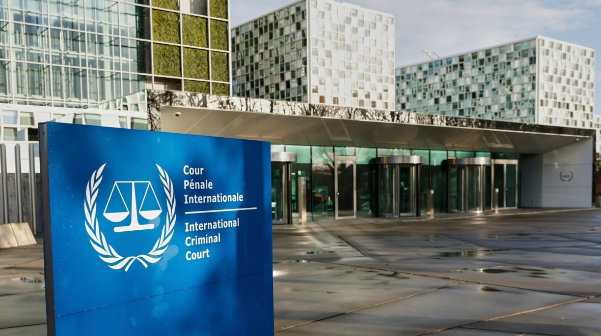 A building is shown from the outside. A sign says International Criminal Court. 