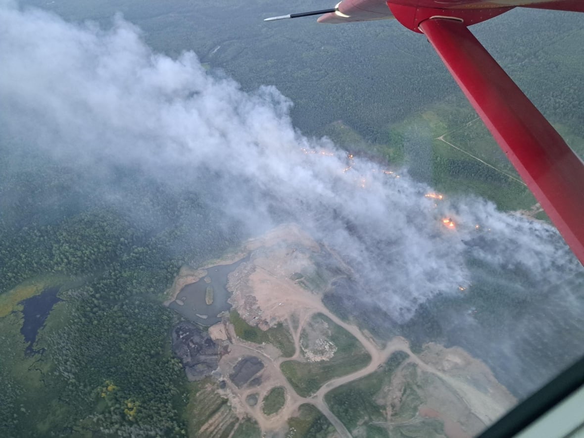 aerial shot of wildfire and plane wing