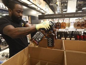 At the Queens Quay LCBO store, staff member Marlon loads up boxes of Jack Daniels as part of the store removing American liquor, wine and beer from their shelves on Tuesday, March 4, 2025.