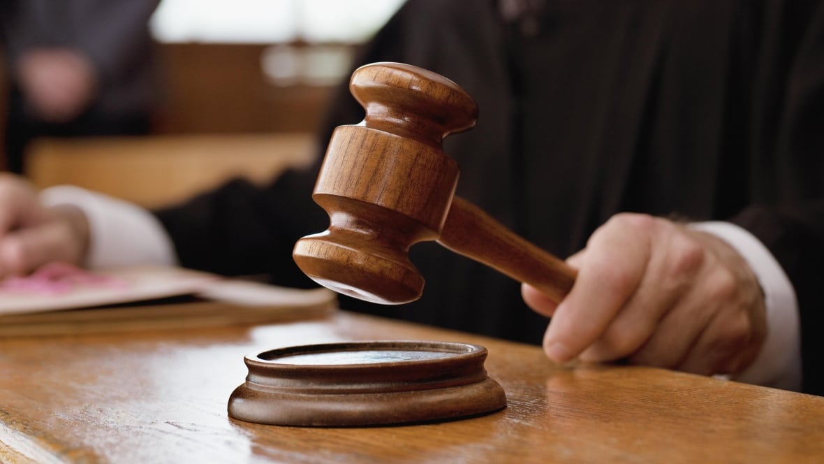 A judge's hand holding a gavel.