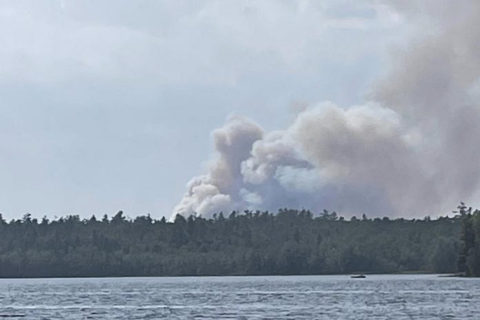 HAL019, a forest fire burning out of control in the area of County Road 49 and County Road 121 between Bobcaygeon and Kinmount in Kawartha Lakes, pictured from Bass Lake. (Photo: Laura Mclennan / Facebook)