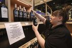 Queens Quay LCBO store staff member Samantha loads up boxes of California wine as part of the LCBO removing American liquor, wine and beer from their shelves on Tuesday, March 4, 2025. 