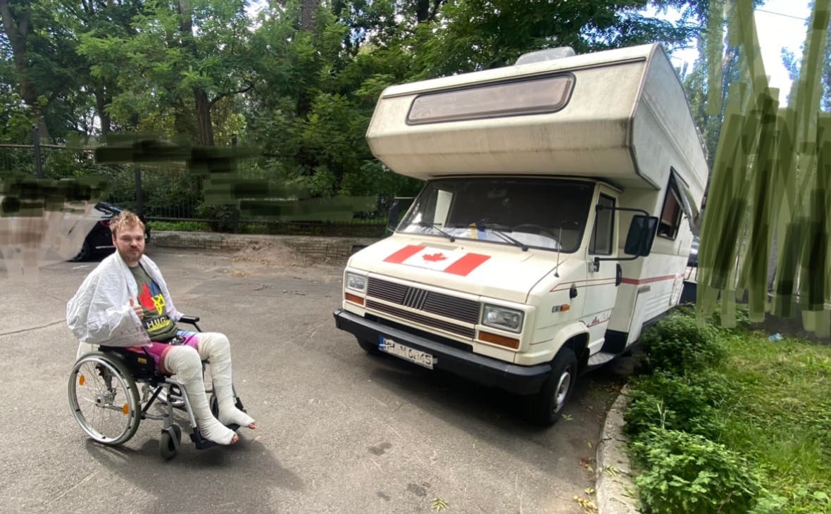 Mac Hughes sits outside of the hospital in Kyiv near the donated RV that his father has been living in as Hughes recovers in the hospital. 