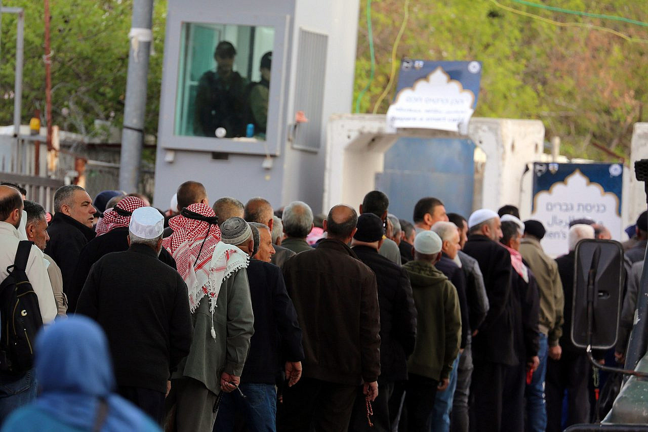 Palestinian worshippers are subjected to extensive checks by the Israeli army as they pass through the Bethlehem checkpoint to go to Jerusalem and the Al-Aqsa Mosque on the second Friday of the holy month of Ramadan, March 14, 2025. (Mosab Shawer/Activestills)