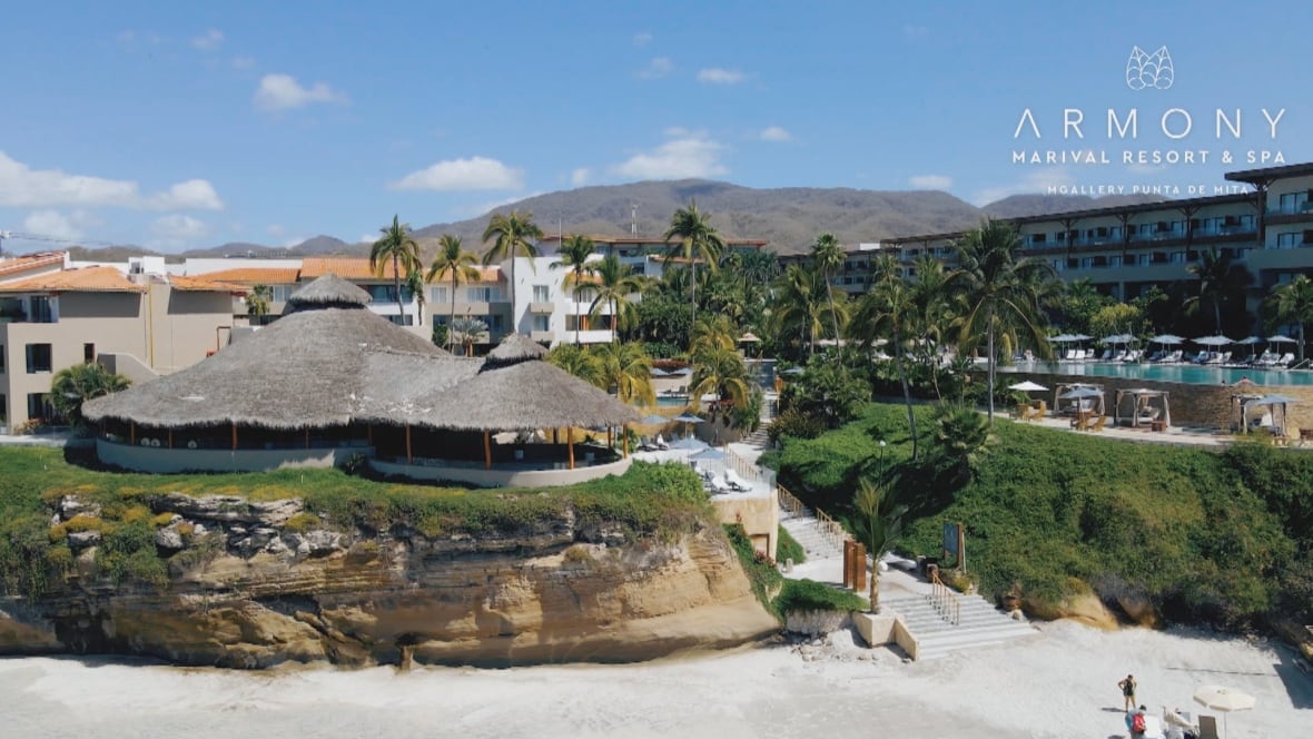 A beachside resort is seen against blue skies.