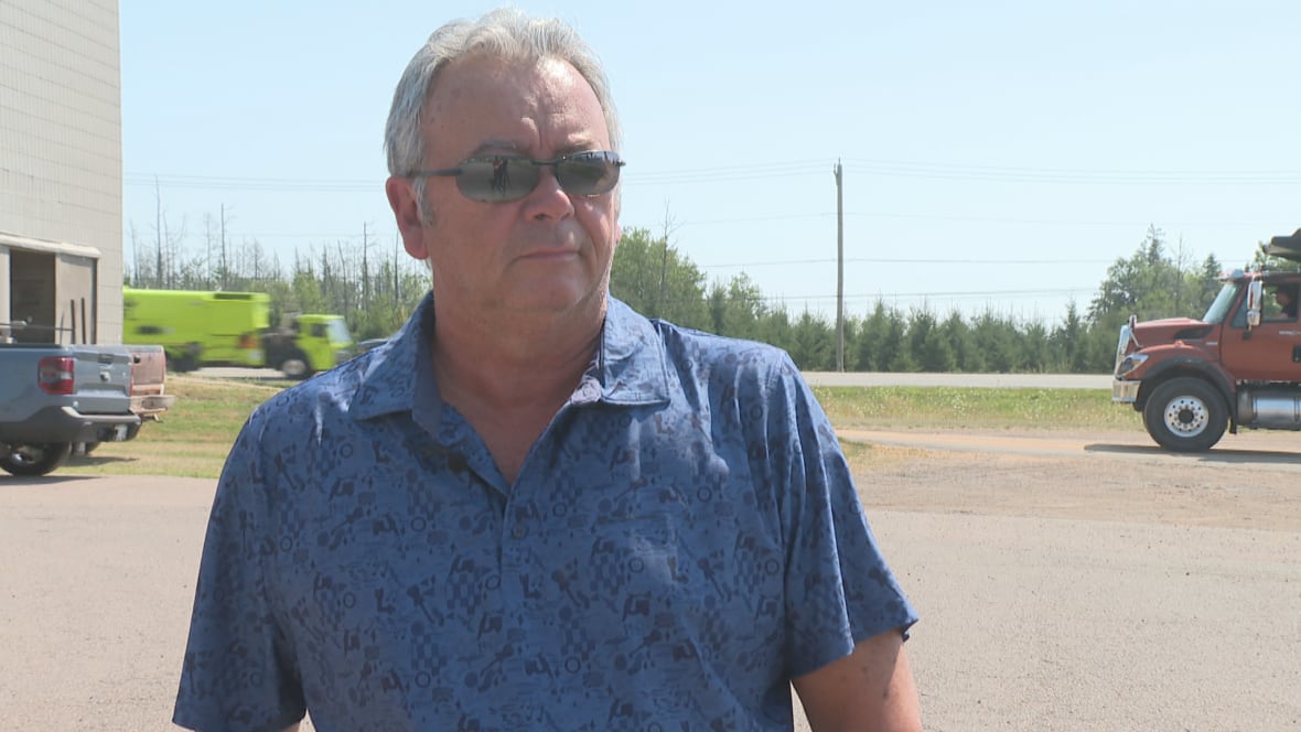 A man in a blue shirt.
