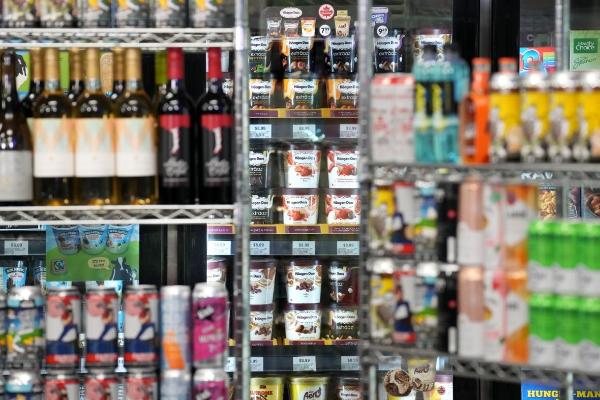 Shelves full of alcoholic beverages of varying sizes, shapes and colour are shown. 