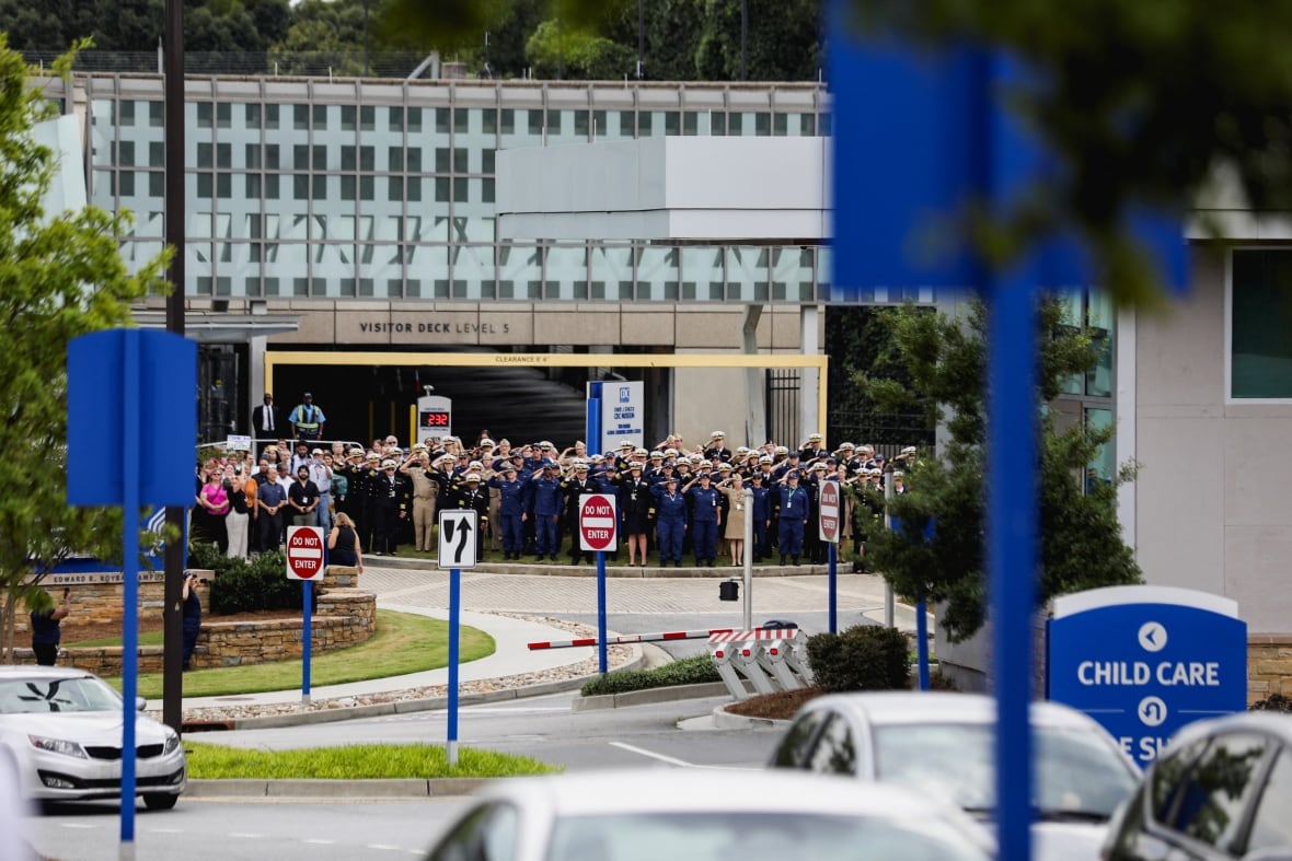 High-ranking CDC members, dressed in uniform, salute senior leaders who resigned from their duties.