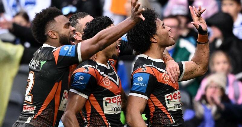 Tigers players appeared to taunt Bulldogs fans with the "khod" gesture after their victory. Photo: Dan Himbrechts/AAP PHOTOS