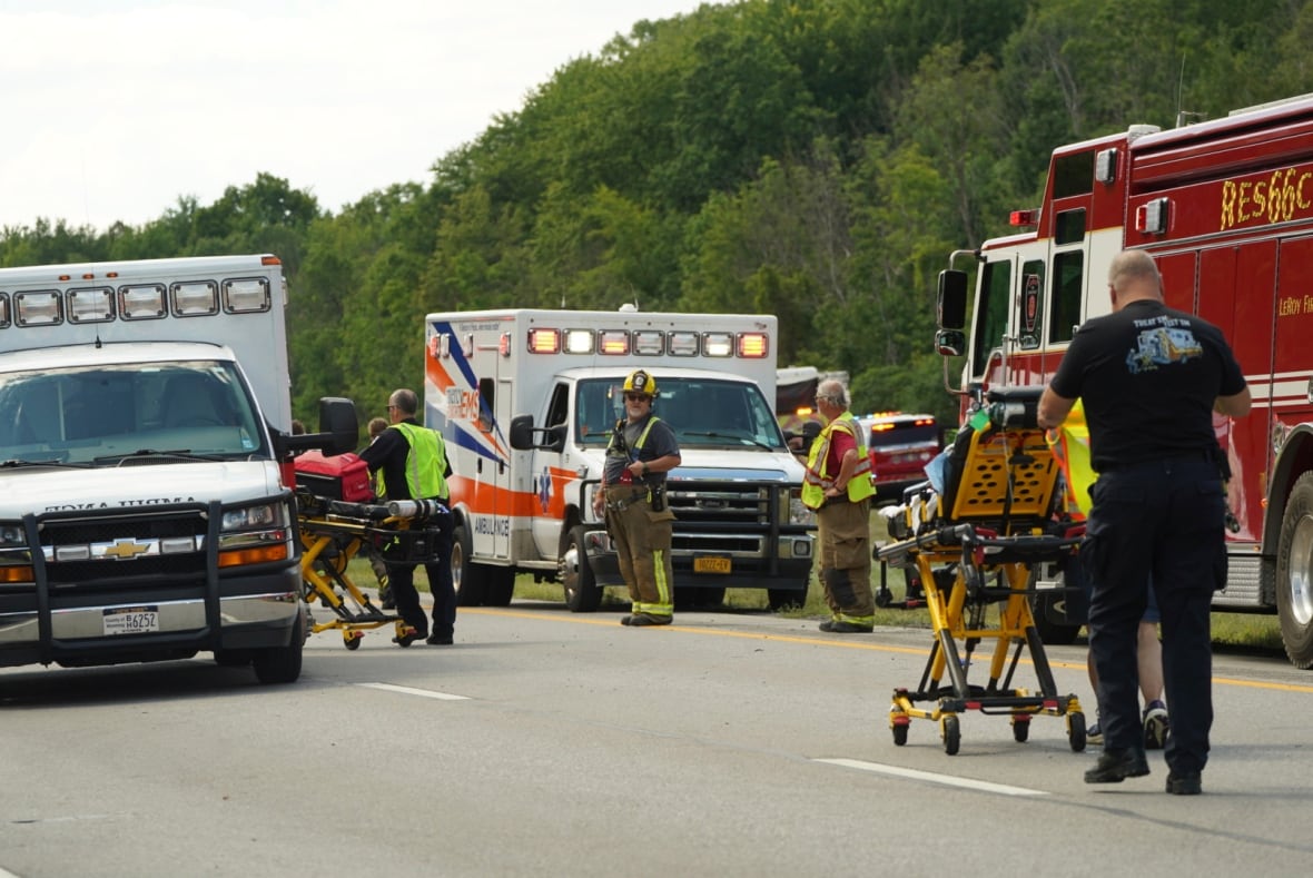 Rescue personnel are seen at work at the site of Friday's crash near Pembroke, N.Y.