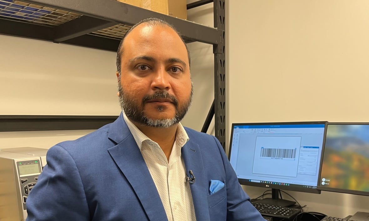 Ritesh Kotak standing in front of a computer