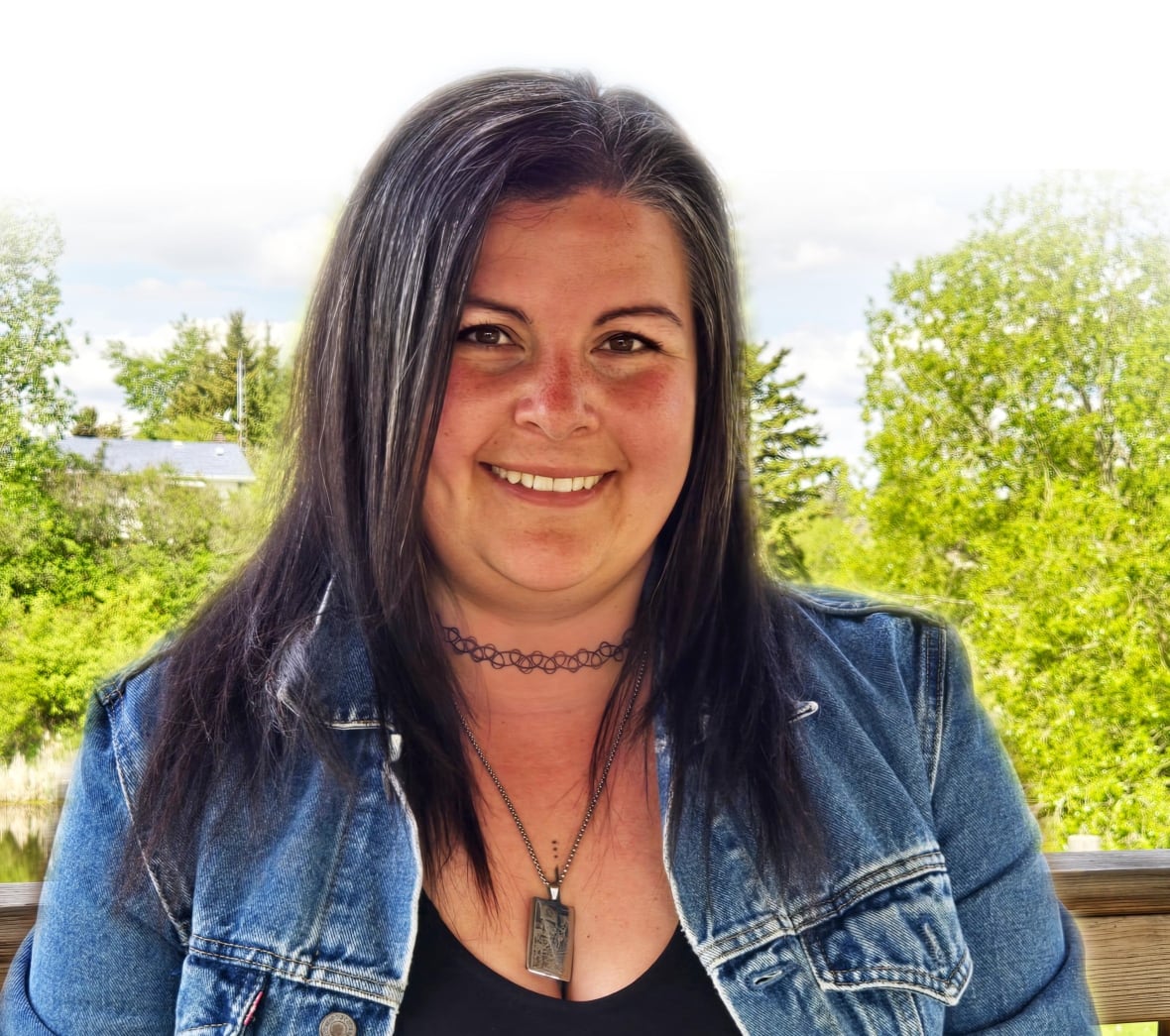 A headshot of a woman in front of trees.