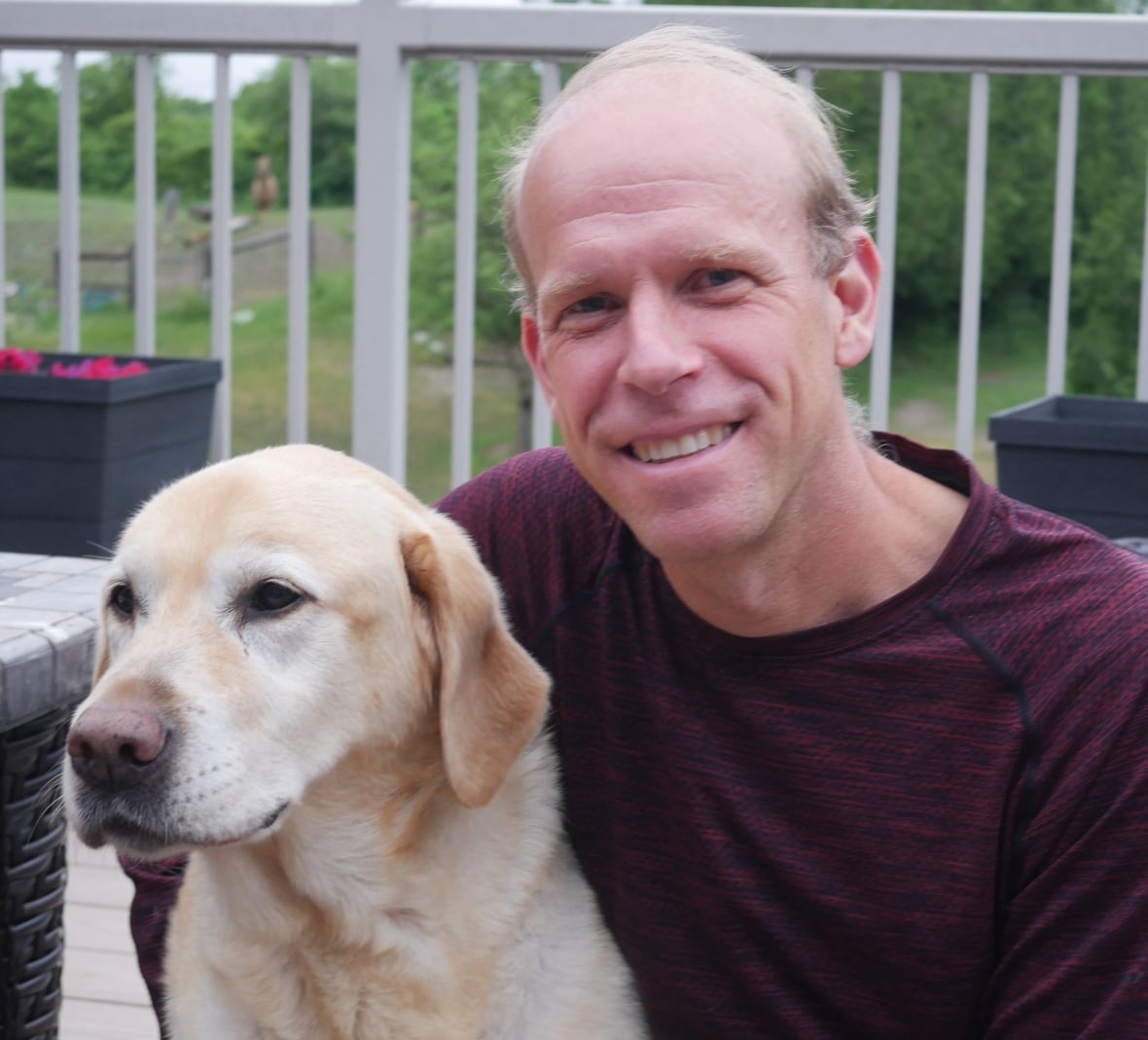 A man with a labrador retriever