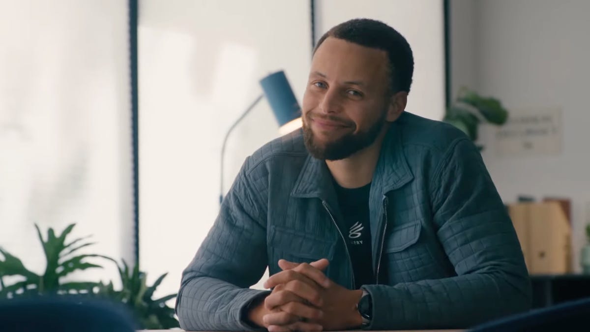 Steph Curry smiling at the camera.