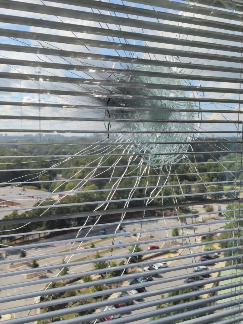 A CDC employee shared these photos with CNN that show bullet holes in glass windows at building 24 of the CDC on Friday.