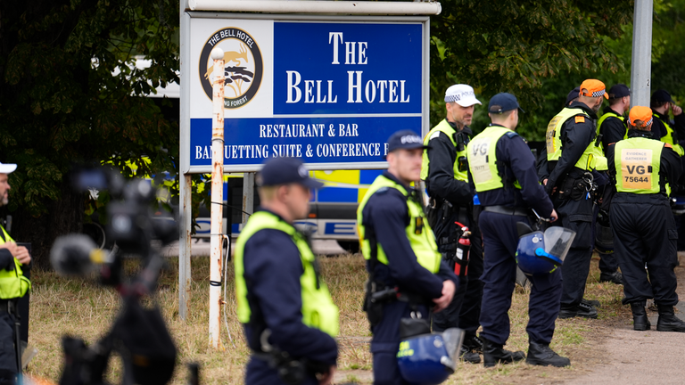 Police officers ahead of a demonstration outside The Bell Hotel in July. Pic: PA