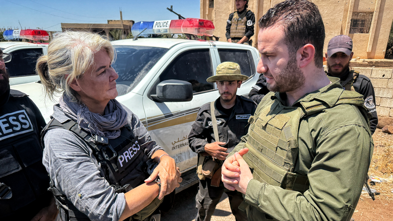 Special correspondent Alex Crawford speaking to a government spokesperson about the sectarian violence