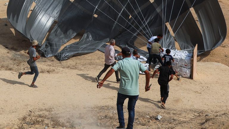 Aid packages being dropped from a plane in Deir Al-Balah. Pic: Reuters