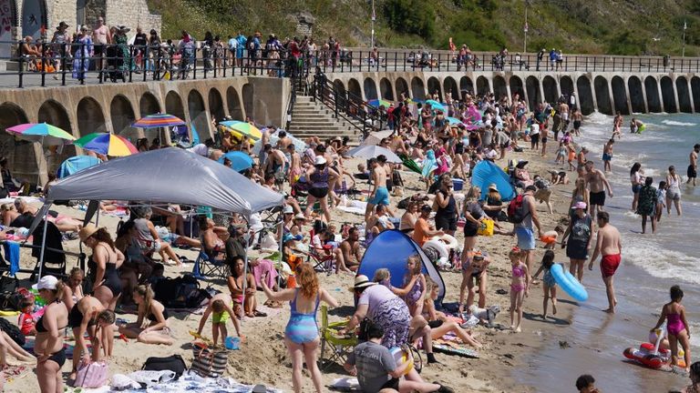 People enjoying the hot weather on Sunny Sands beach in Folkestone last month. Pic: PA  