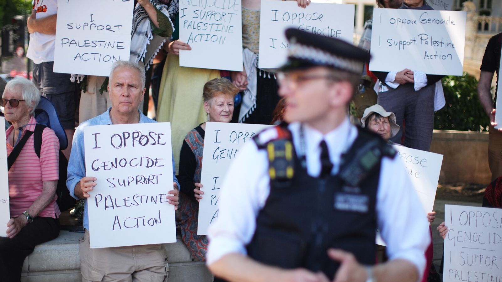 People take part in a protest in Parliament Square, London, to call for de-proscription of Palestine Action. Pic: PA
