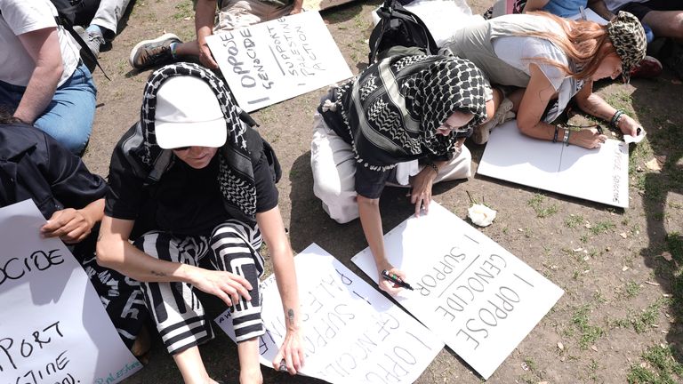 Protesters write on placards for the Lift the Ban campaign rally on Saturday. Pic: PA