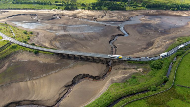 A drone view from June shows vehicles using a bridge to pass over a dry section of the Woodhead Reservoir. Pic: Reuters