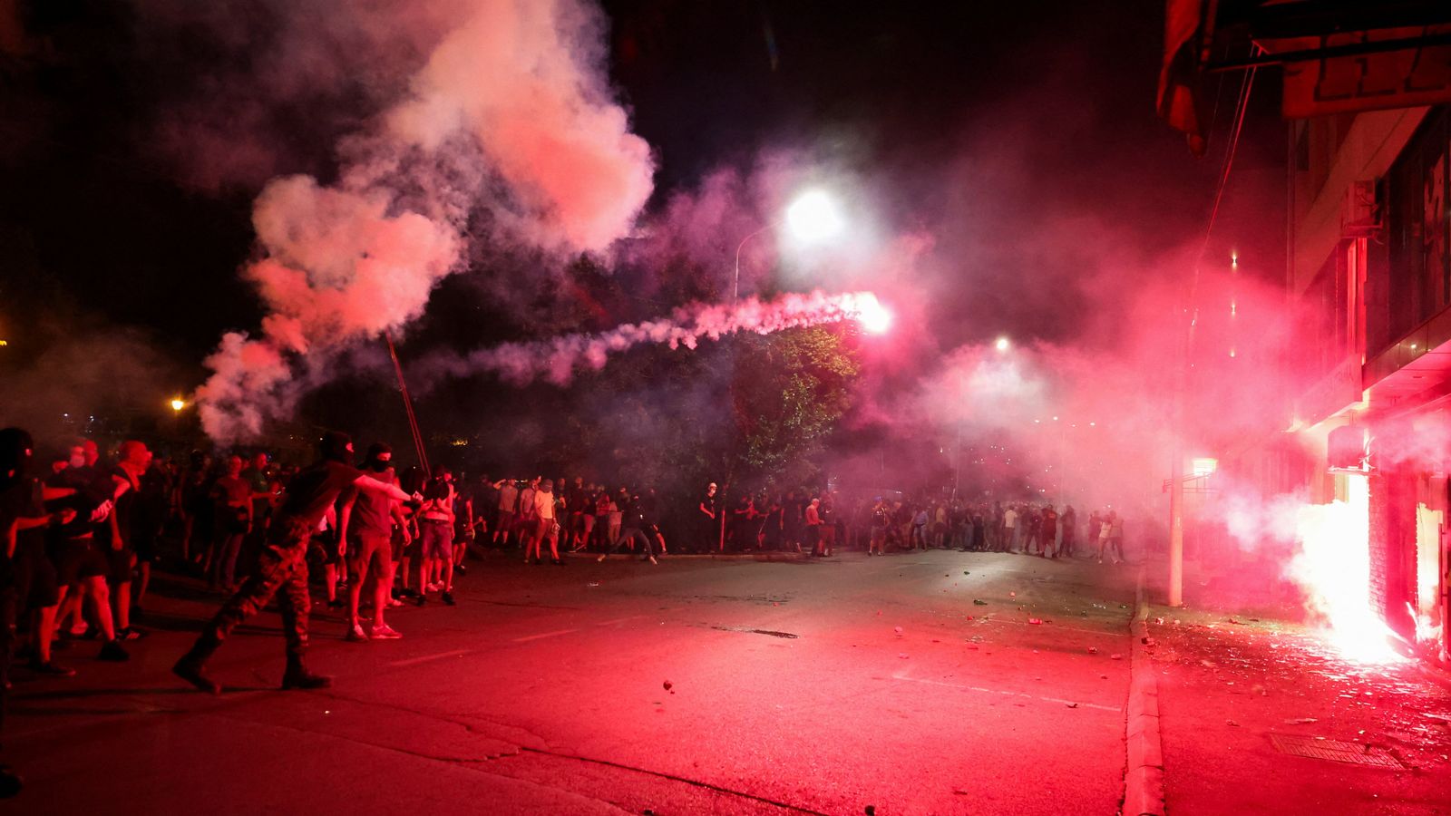 Anti-government protesters throw fireworks at the offices of the ruling Serbian Progressive Party. Pic: Reuters