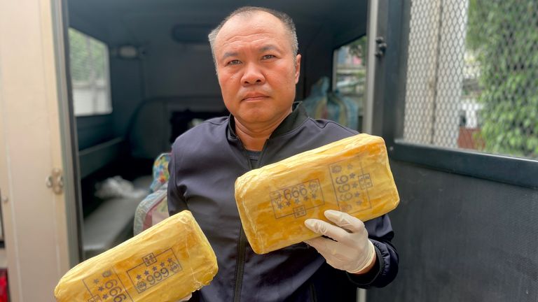 Lt Col Kantatat Yathoum, police inspector, hold seized packs of Yaba