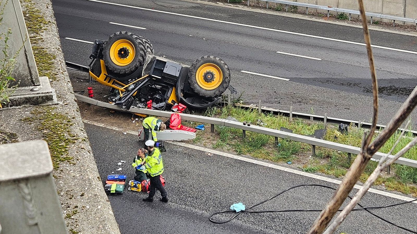 Man seriously injured after tractor falls off bridge on to M20 | UK News