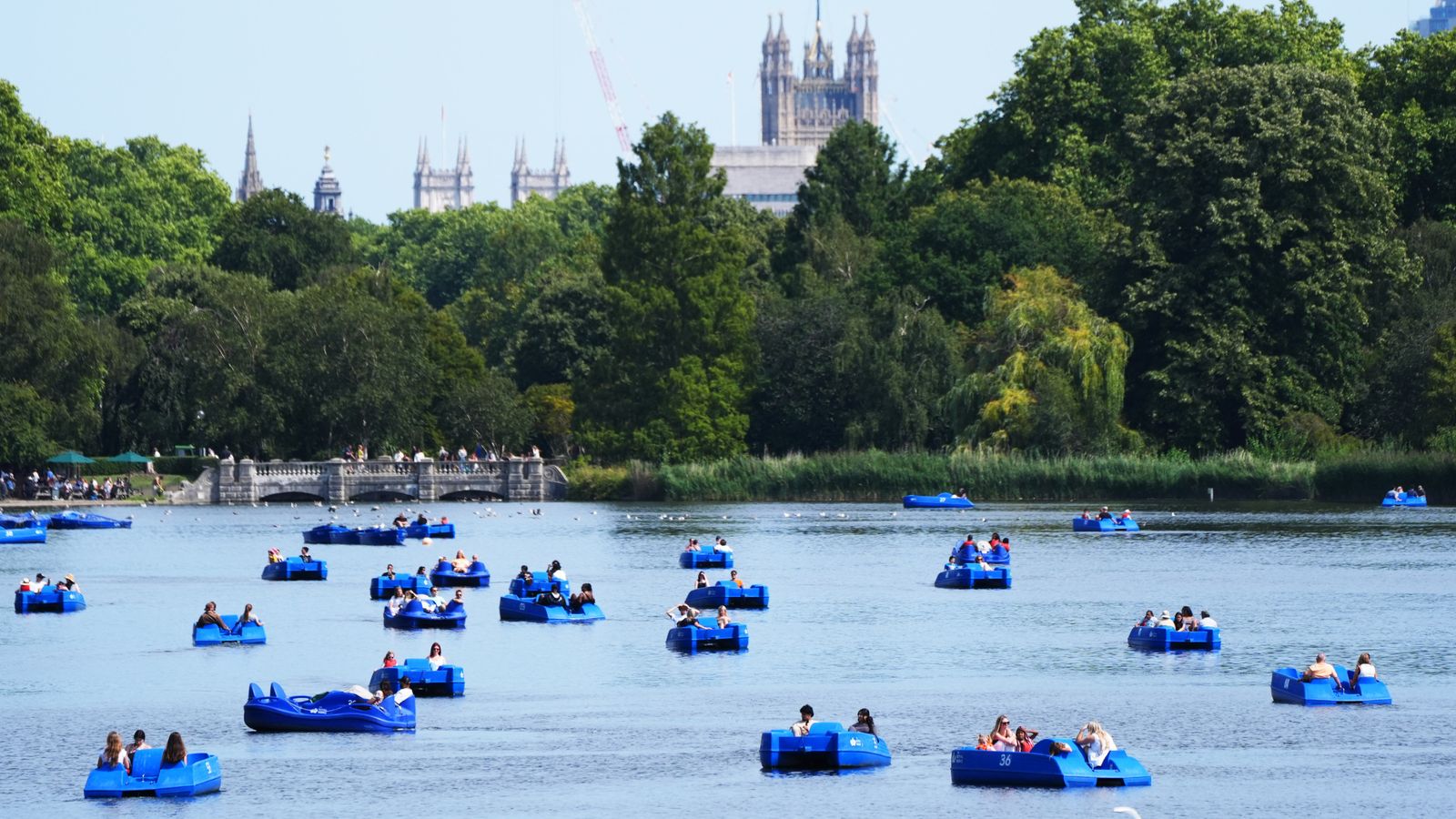 People ride pedalos in Hyde Park, London. Pic: PA