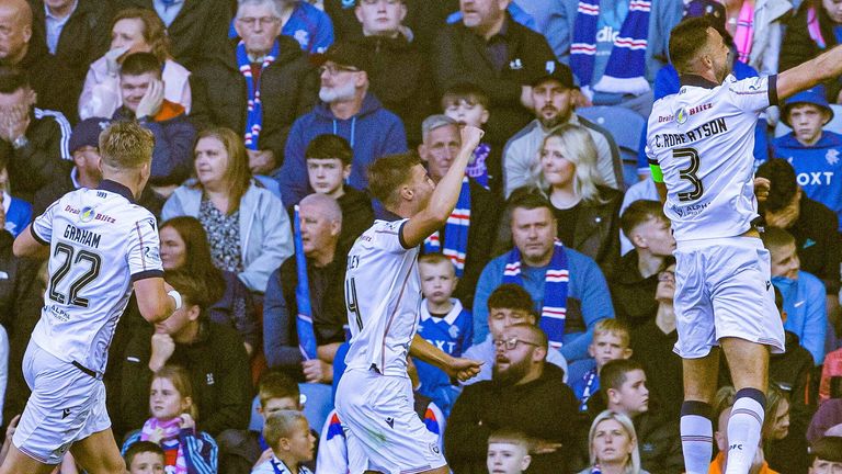 GLASGOW, SCOTLAND - AUGUST 09: Dundee's Ryan Astley (C) celebrates scoring to make it 1-0 with teammates Luke Graham (L) and Clark Robertson during a William Hill Premiership match between Rangers and Dundee at Ibrox Stadium, on August 09, 2025, in Glasgow, Scotland. (Photo by Alan Harvey / SNS Group)