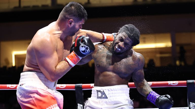 Filip Hrgovic hurts David Adeleye in their heavyweight bout.