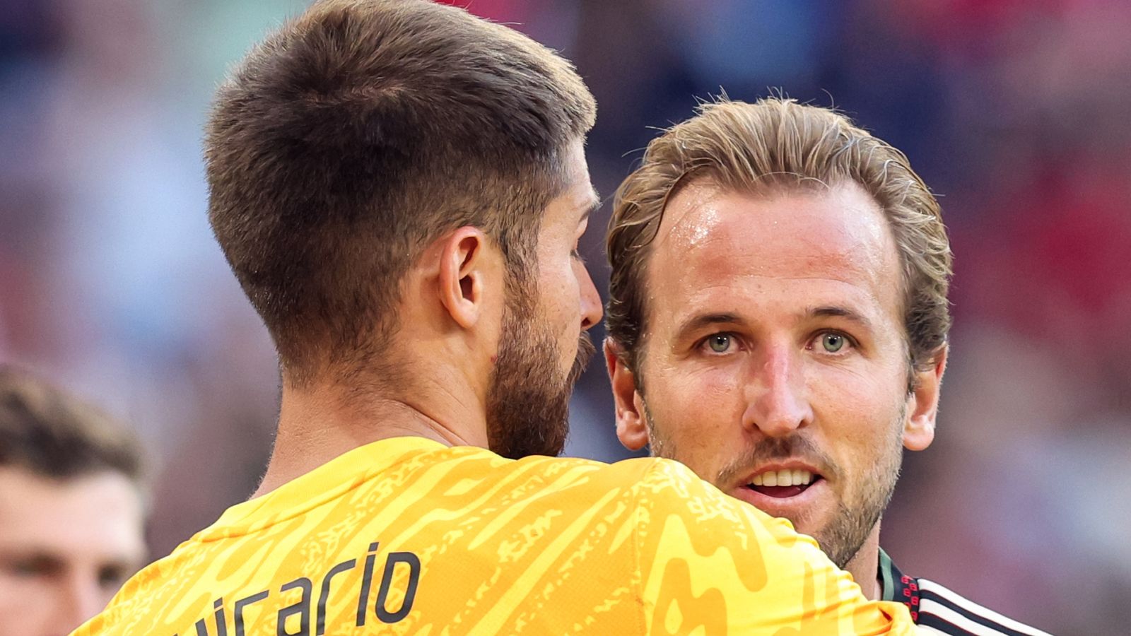 Guglielmo Vicario (left) and Harry Kane embrace during Bayern Munich's 4-0 win over Tottenham in pre-season