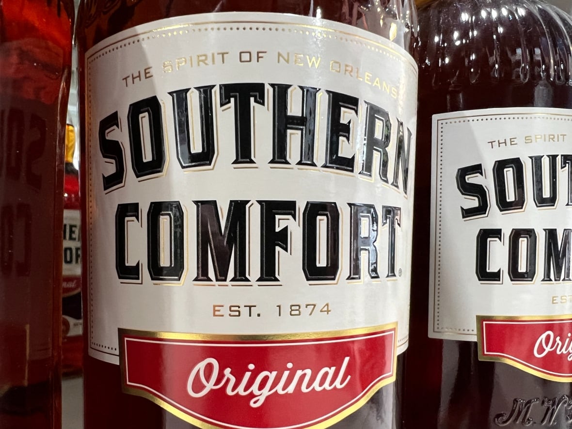 A bottle of Southern Comfort alcohol is shown on a NSLC shelf.