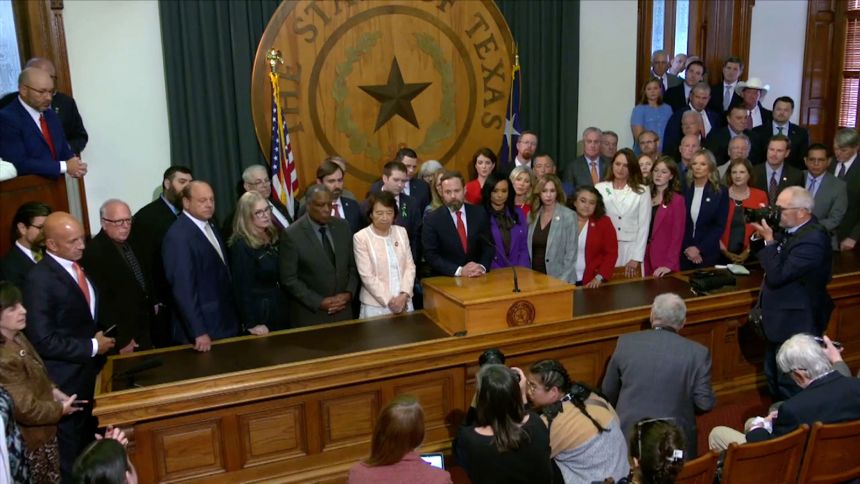 Dustin Burrows, the Republican speaker of the Texas House, center, speaks during a press conference on Monday, in Austin, Texas.