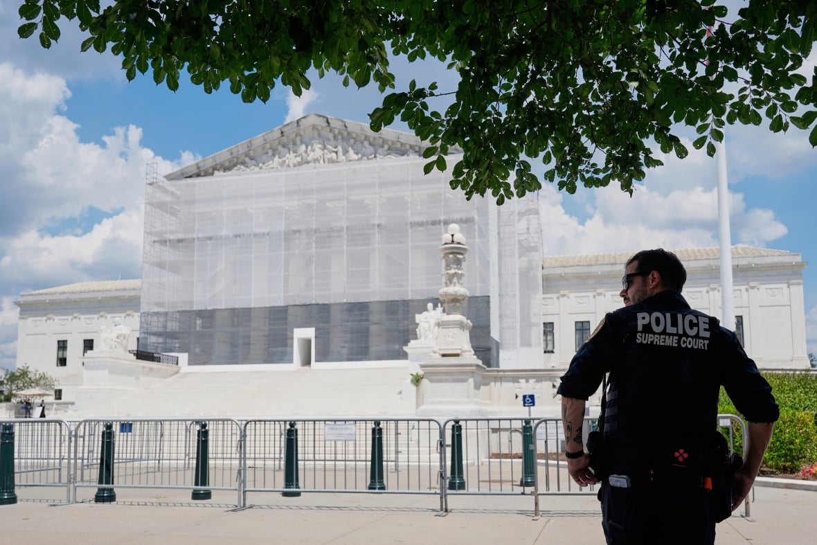 A U.S. Supreme Court police officer stands watch outside of the Supreme Court, June 26, 2025, in Washington.