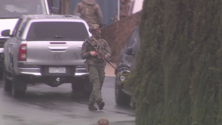Tactical police in Porepunkah, as the search for a fugitive gunman continues. 