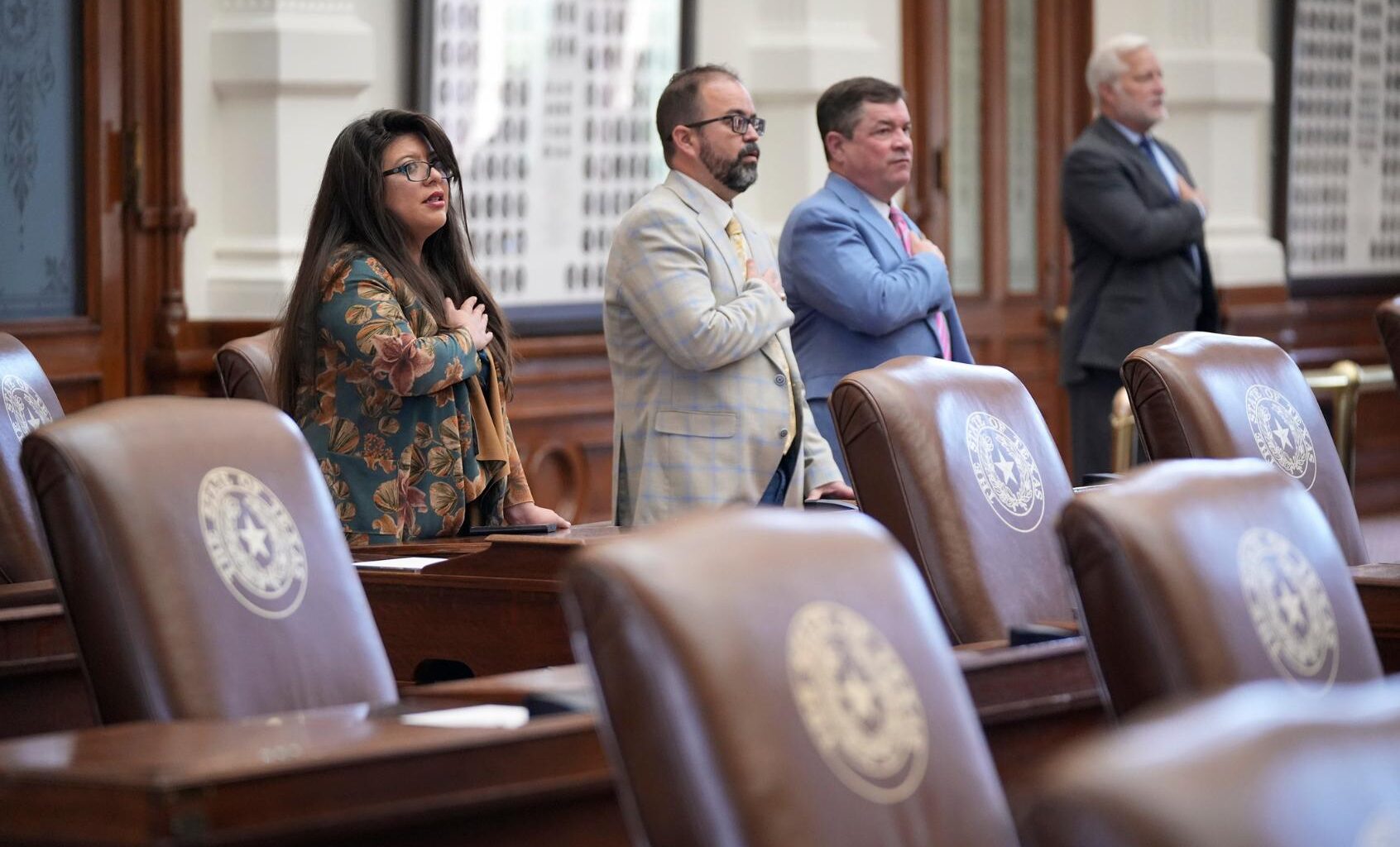 Rep. Mary Gonzalez, D-Clint, Rep. Joe Moody, D-El Paso, and Rep King King, R-Canadian, stand for the Pledge of Allegiance in the House Chamber at the Capitol in Austin, Friday, Aug. 8, 2025. (Jay Janner/Austin American-Statesman via Getty Images))