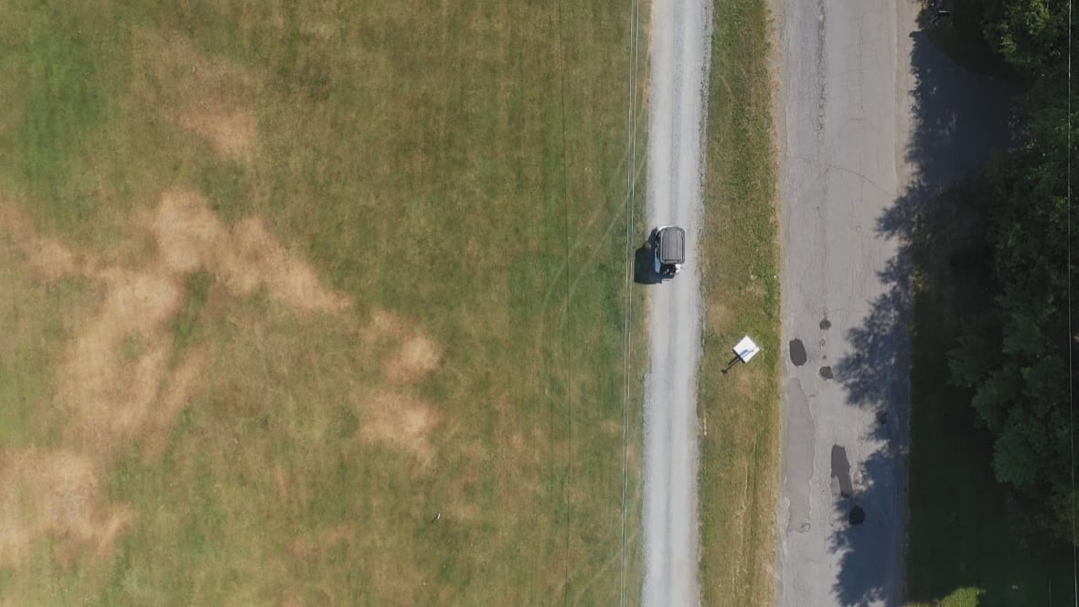 A drone photo of two paths separated by a border marker.