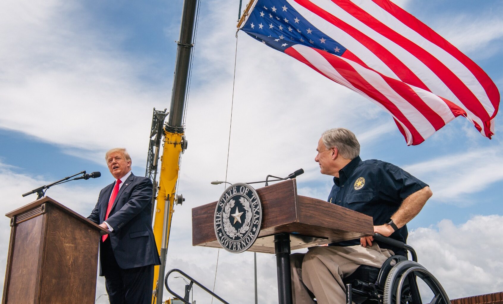 Texas Gov. Greg Abbott listens to President Donald Trump's address during a tour to an unfinished section of the border wall on June 30, 2021 in Pharr, Texas. (Brandon Bell/Getty Images)