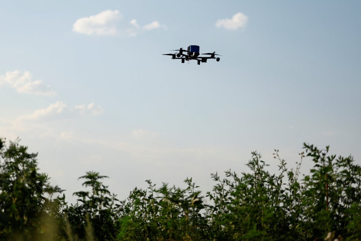 A drone is seen flying in the air.
