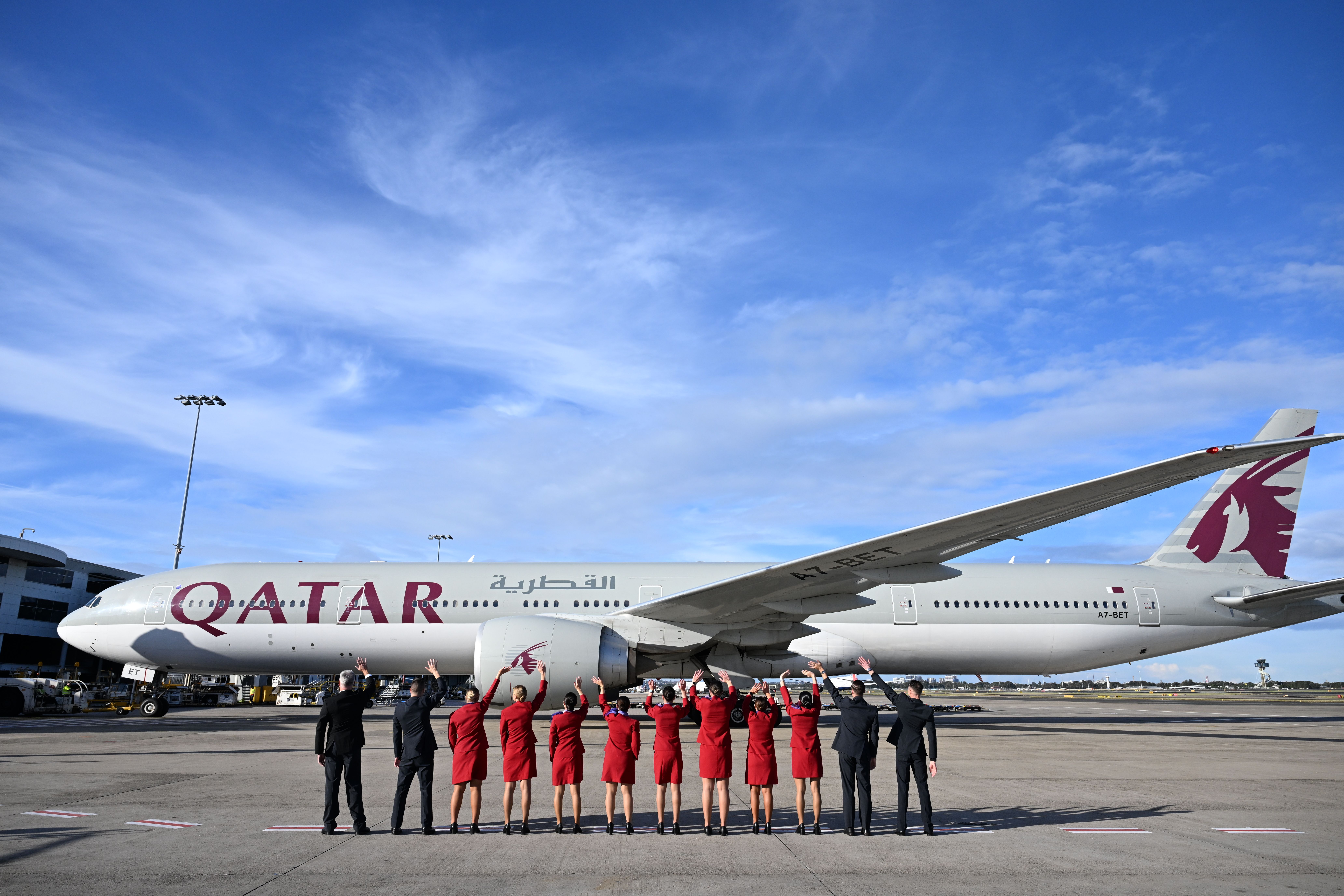 Virgin Australia flight attendants waving off a Qatar Airways Boeing 777-300ER