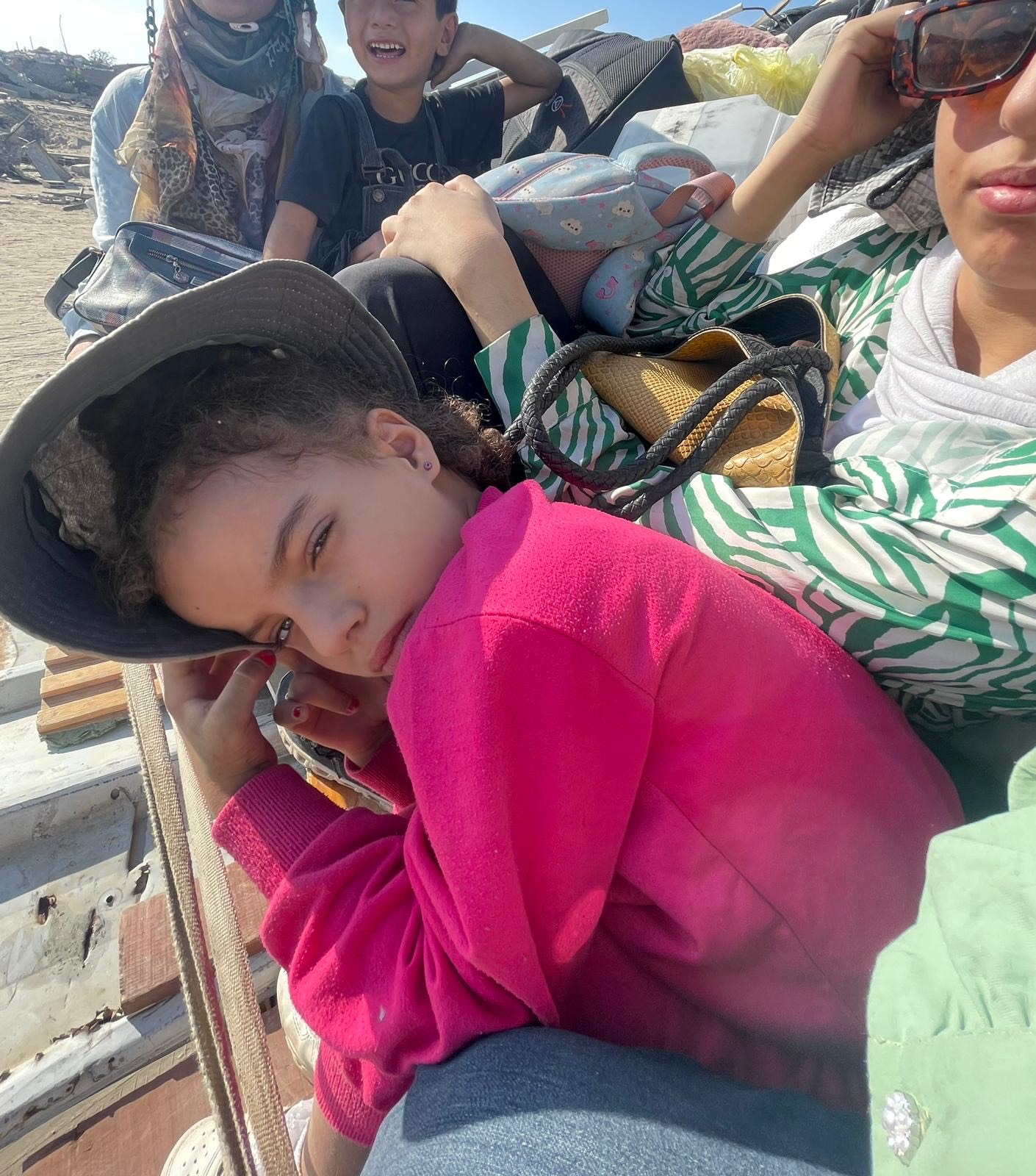 Exhausted 7-year-old Sarah during family displacement.